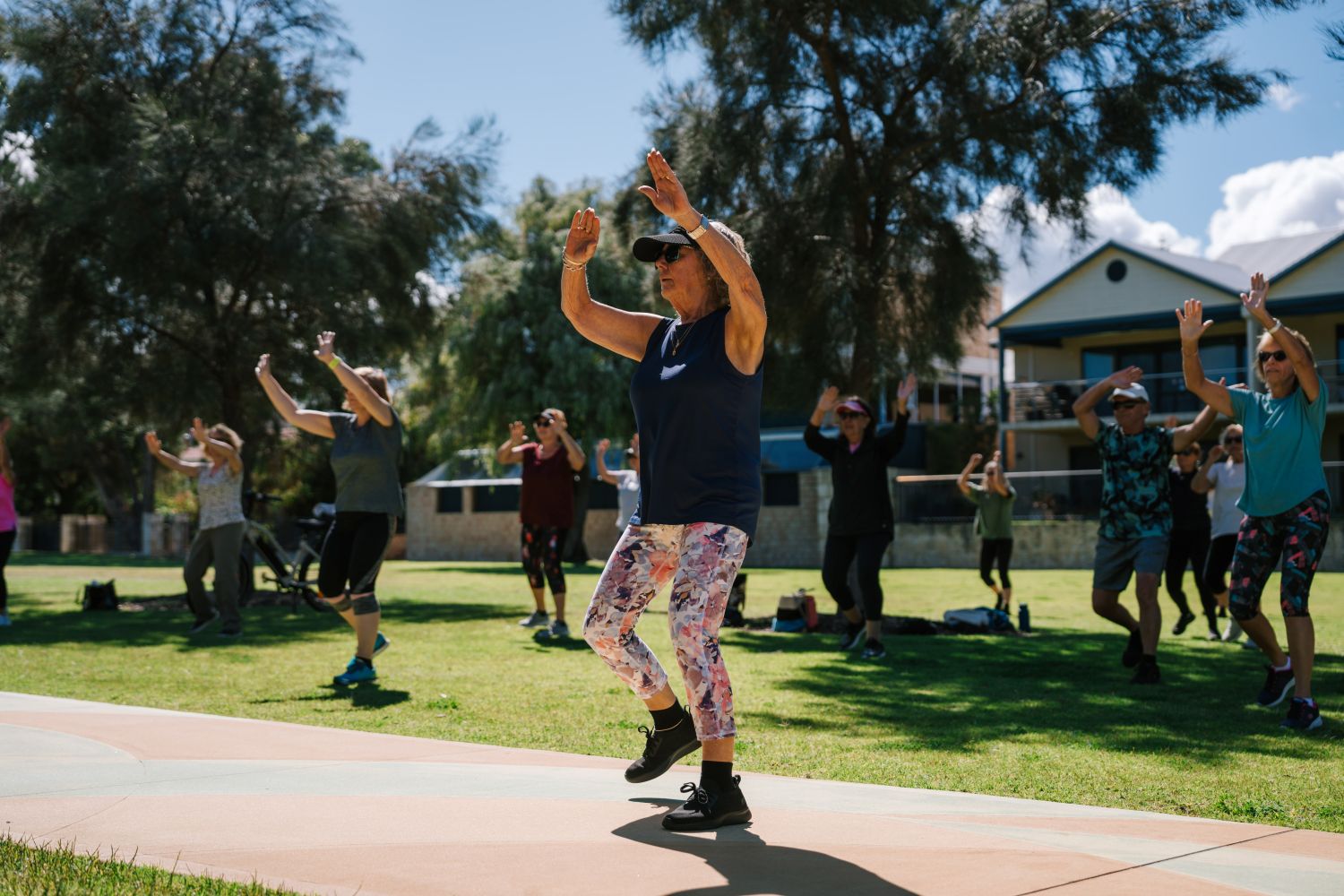A woman participating in an outdoor fitness class